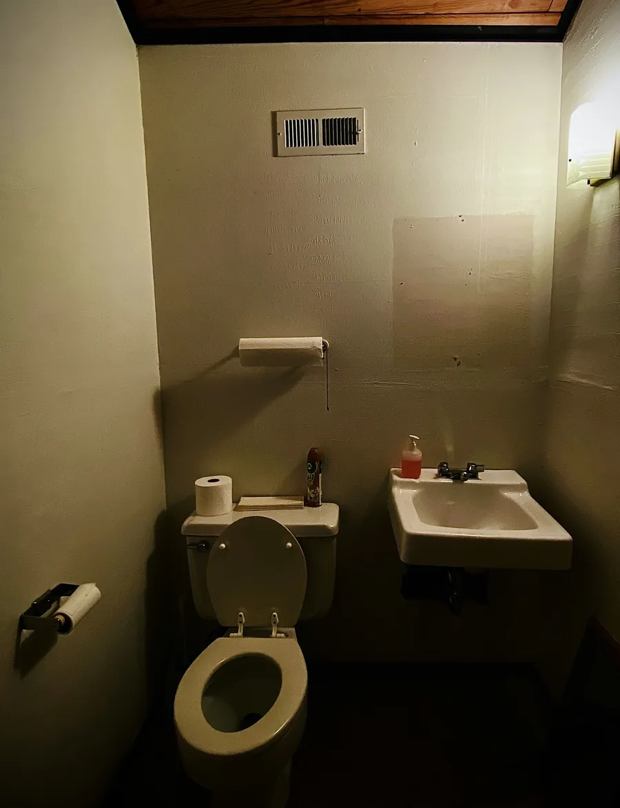 A photo of a sad looking bathroom with no bathroom mirror.
