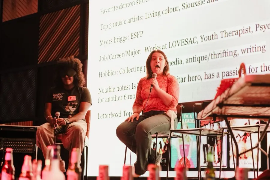 A woman's mouth is open in shock as she finds out she won the dating game.