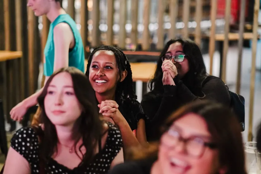 Audience members smiling.