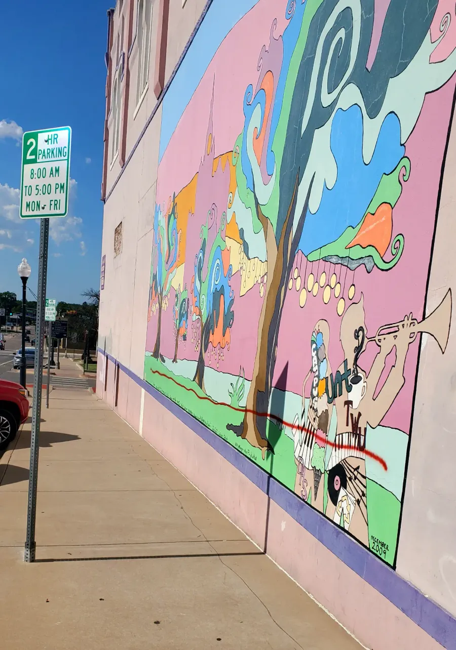 A red line of spray paint covering the mural at Recycled Books