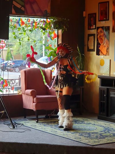 Smiley the clown (instagram: Lettuceeraser) performs on stage.